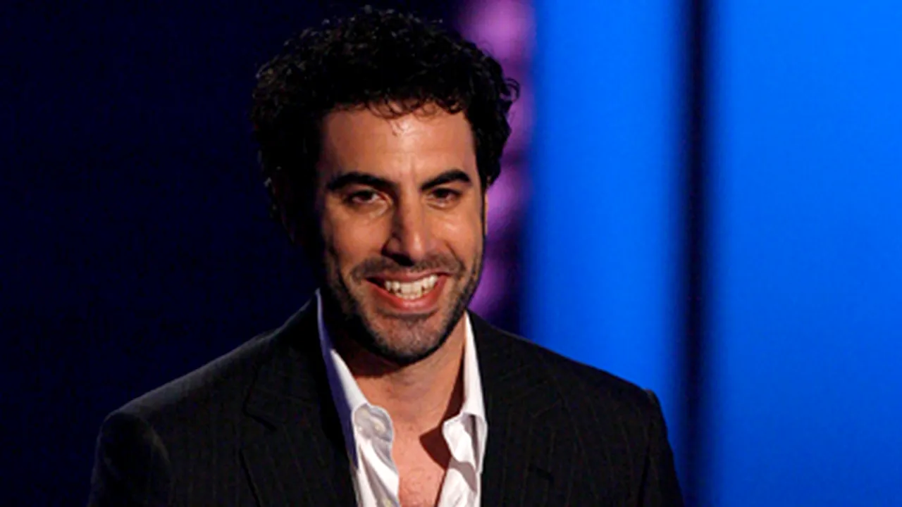 Sacha Baron Cohen trece de la ţăranii din Glod la Indiggo şi 