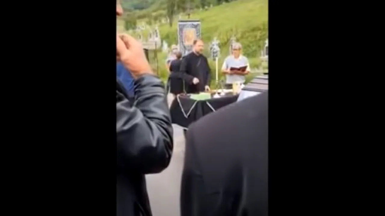 VIDEO: Preot sancţionat după ce a cerut bani de înmormântare şi a pretins să îi fie sărutată mâna