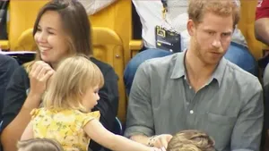 IMAGINILE ZILEI: O fetiţă mănâncă pe furiş din punga de floricele a prinţului Harry, în timpul jocurilor Invinctus