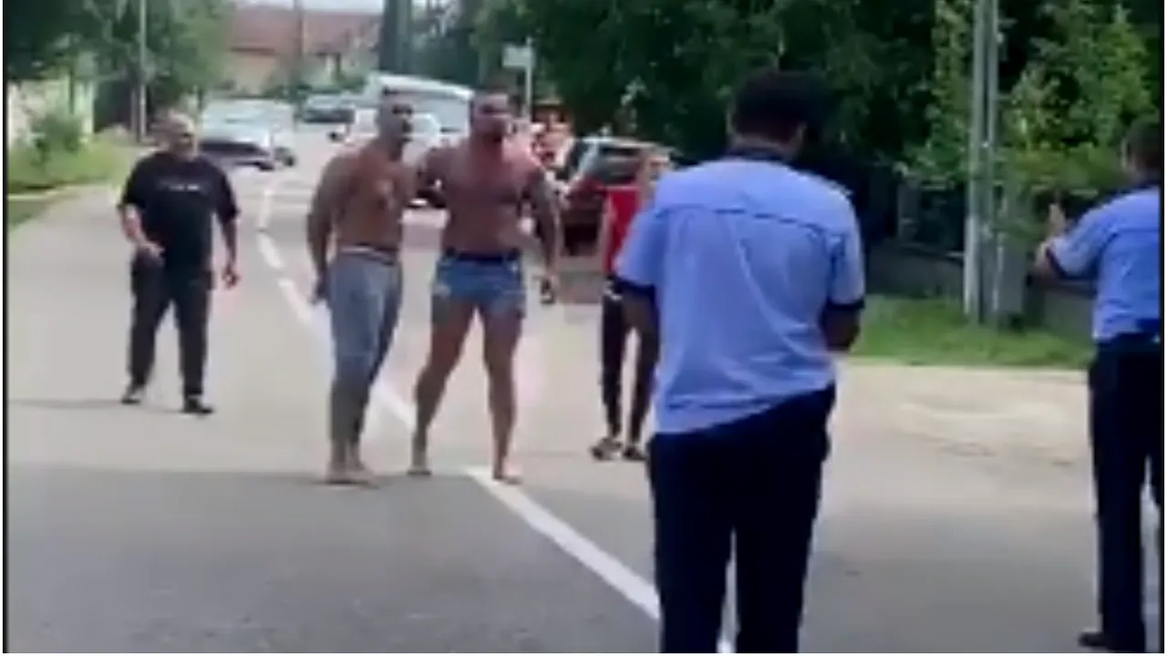 VIDEO: Doi poliţişti, chemaţi să aplaneze un conflict, au fost ameninţaţi în plină stradă. „Vrei să te bat cu pistolul în mână?