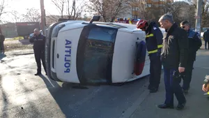 Accident în Capitală. Autospecială a Poliţiei, răsturnată după ce a fost lovită de o altă maşină. FOTO